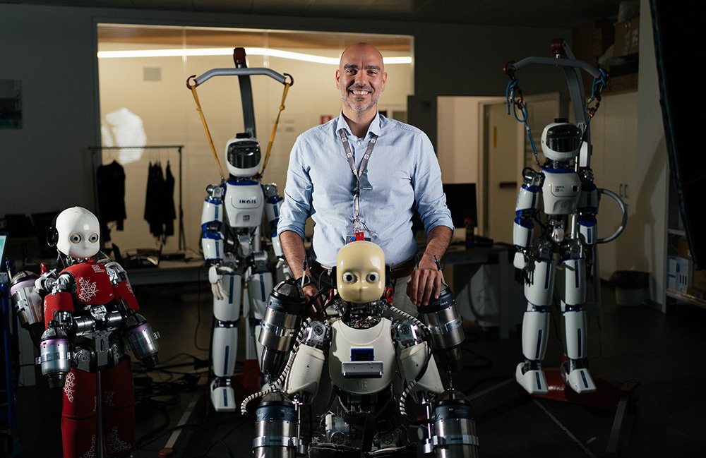 Daniele Pucci with four humanoid robots developed at IIT.